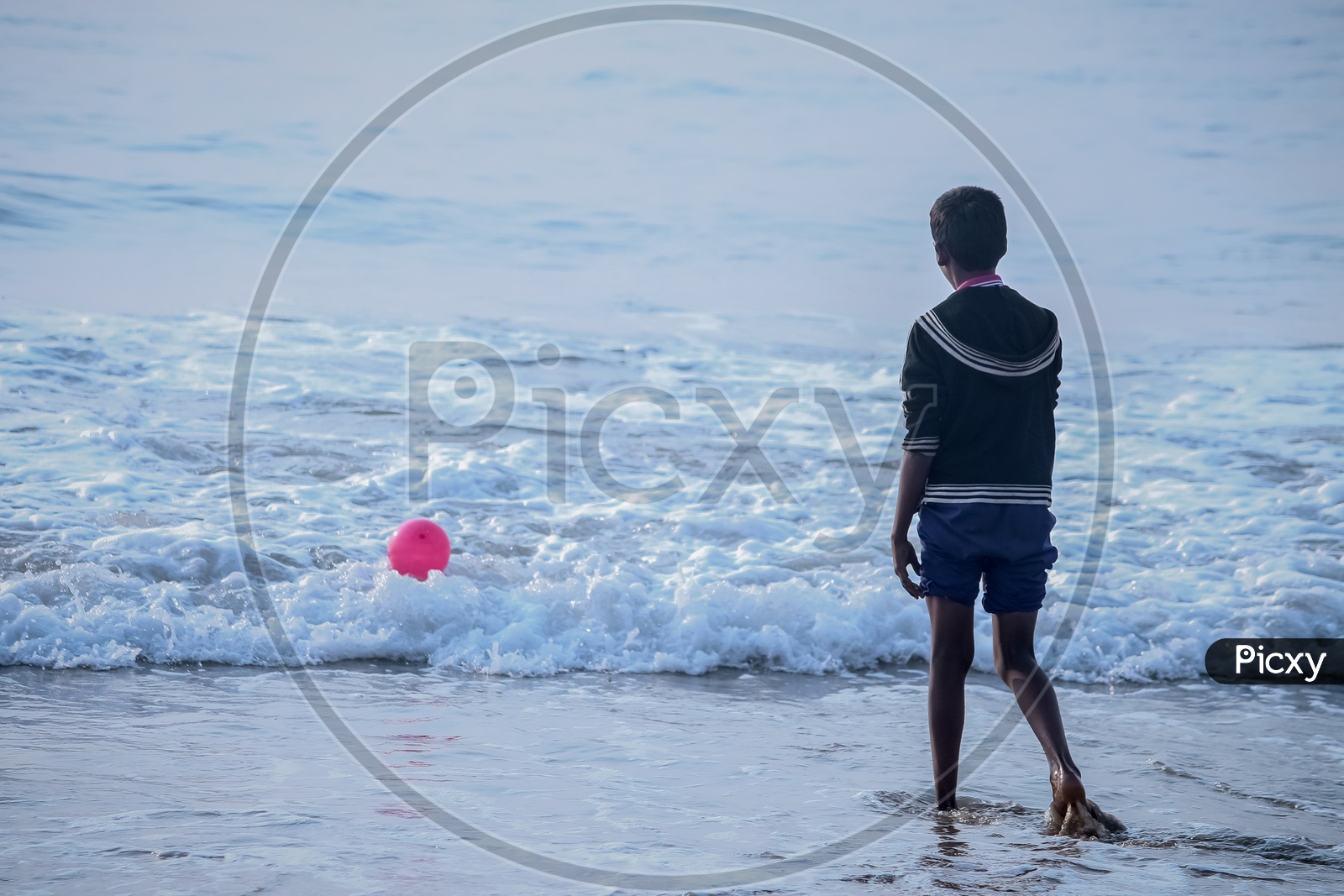 Boy playing with balloon at RK Beach