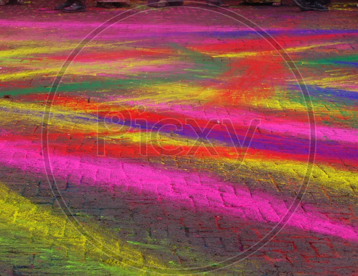 Mixed colours of Rangoli on the ground