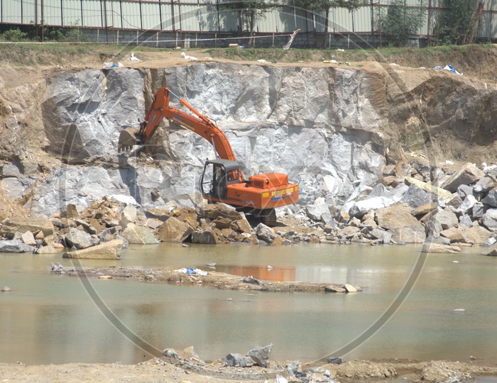 Bulldozer quarrying the massive rock bodies at a construction site