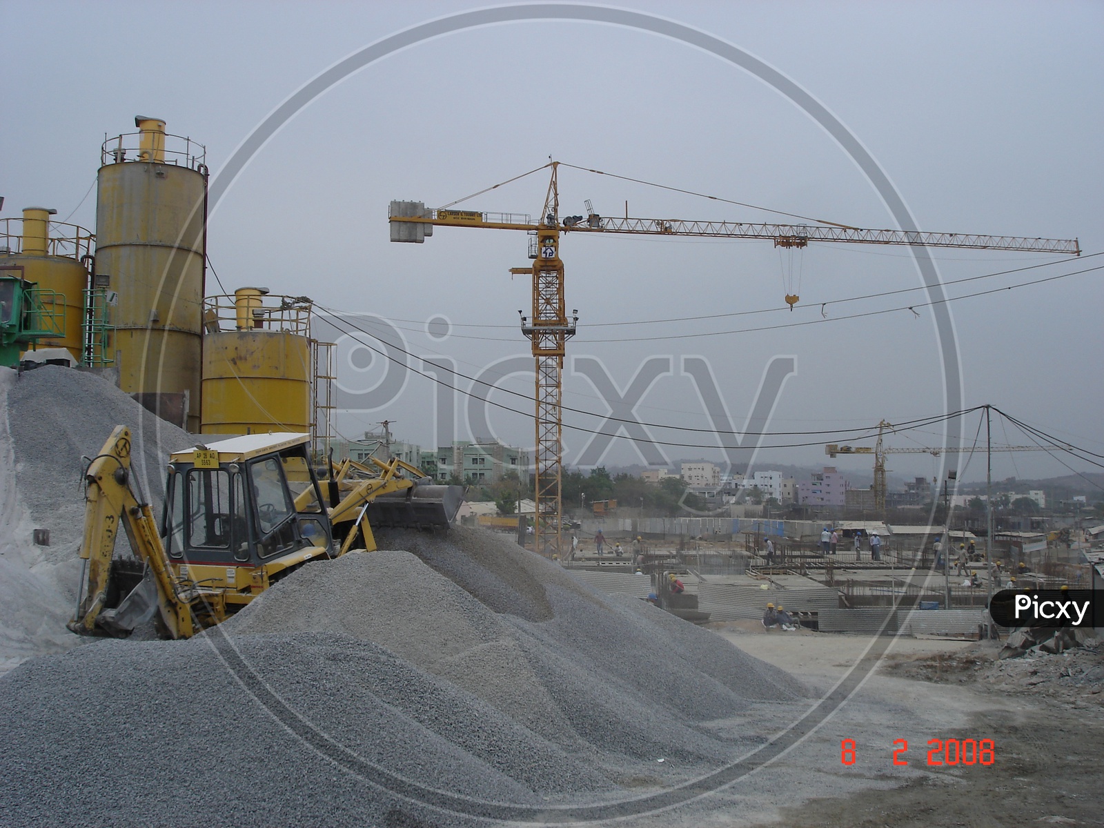 Basalt powder heap alongside the grinder machinery and the tower crane