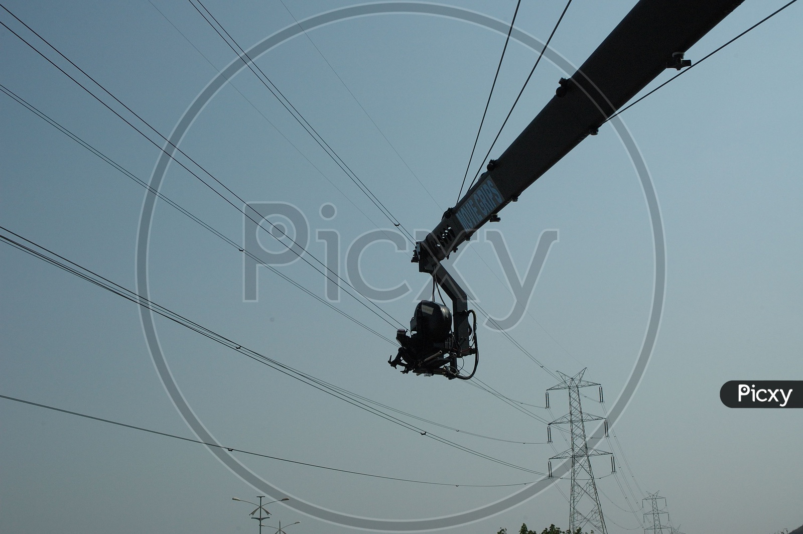 Camera Crane jib with electric tower in background