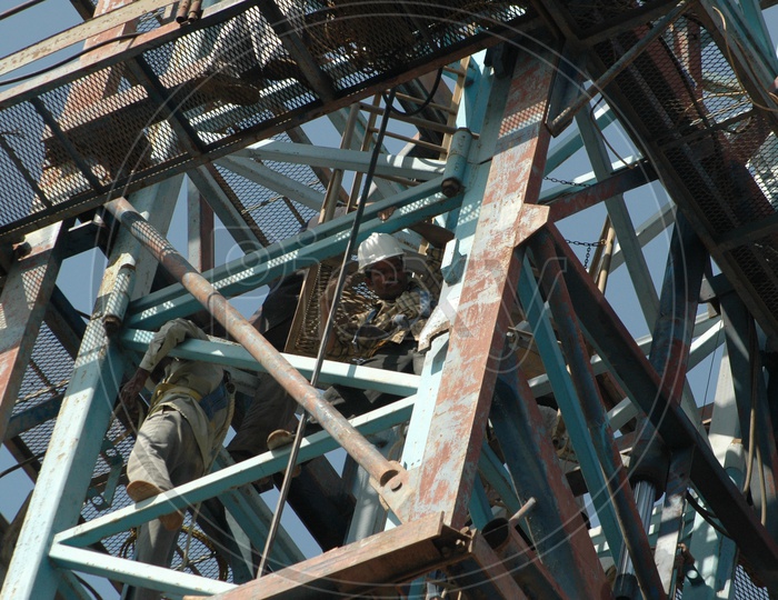 Group of workers working alongside the crane equipment