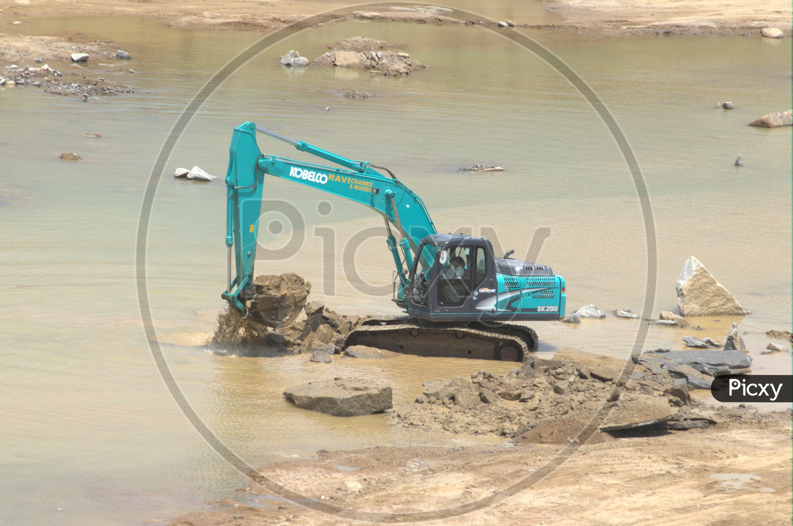 Bulldozer excavating the rocky layers in the mud