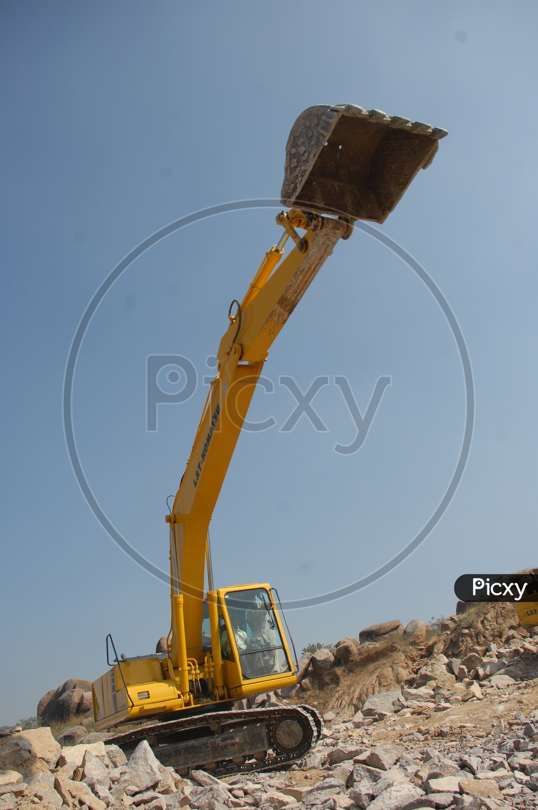 Bucket of the bulldozer excavating the rocks at a construction site