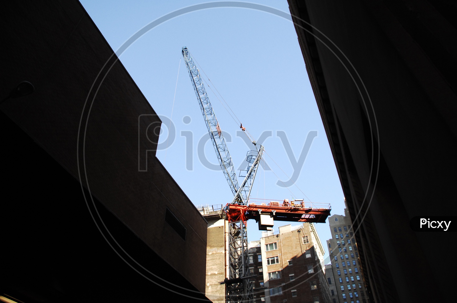 Tower crane alongside the High Rise Buildings with clear sky in background