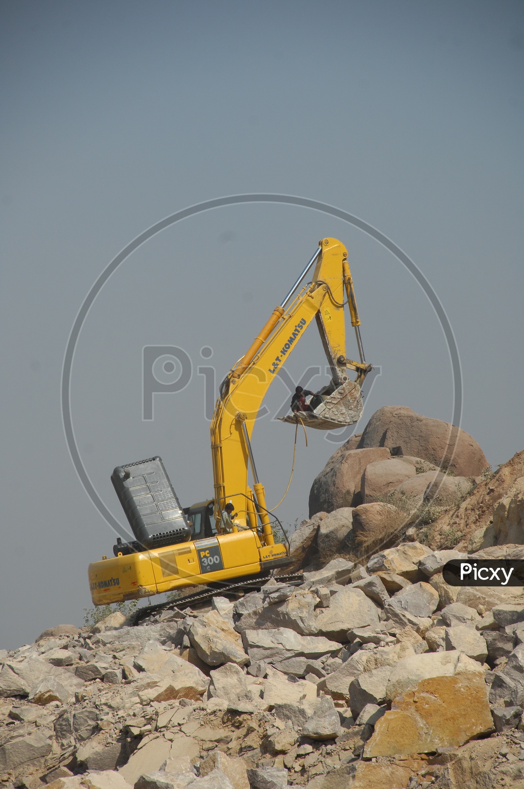 Man in the bulldozer bucket at a construction site