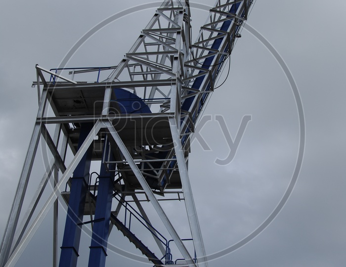 Crane equipment with cloudy sky in background
