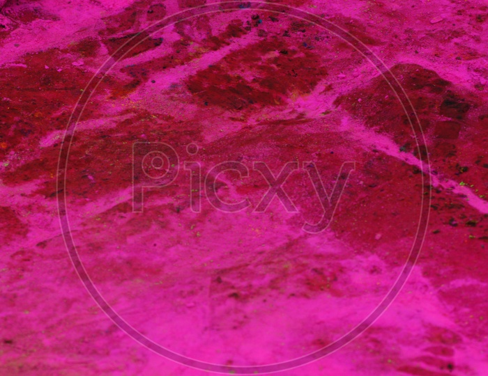 Pink colour of Rangoli on the bricks
