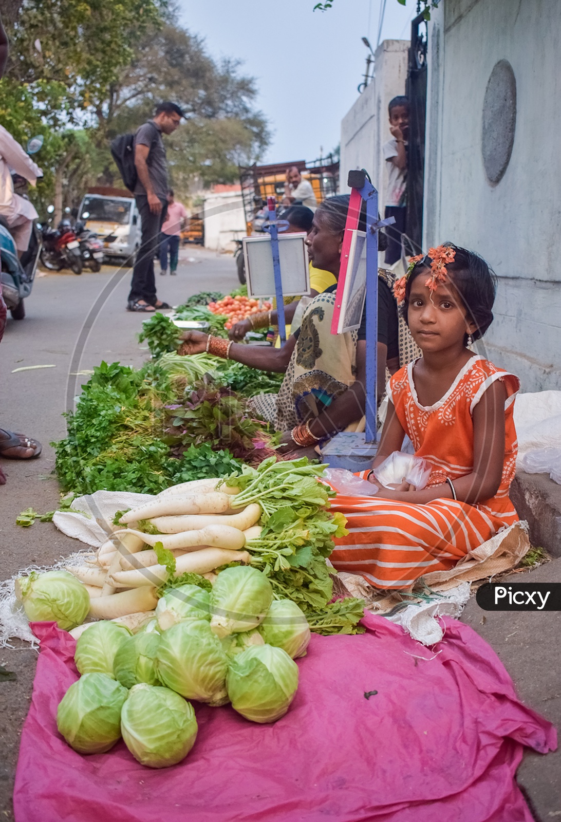 girl child selling vegetables