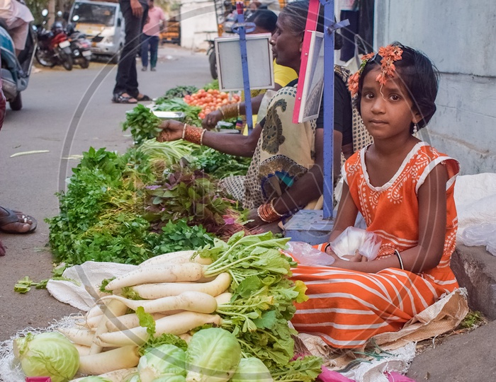 girl child selling vegetables