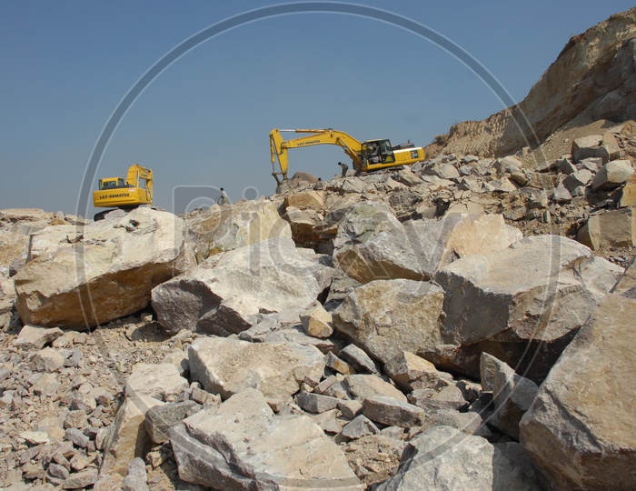 Bulldozer quarrying the construction rocks of a hill at construction site