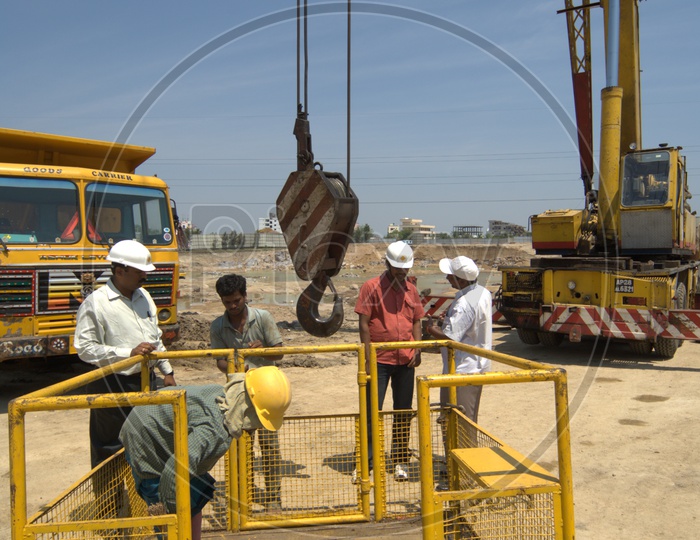 Construction engineers and crane operators inspecting the crane equipment