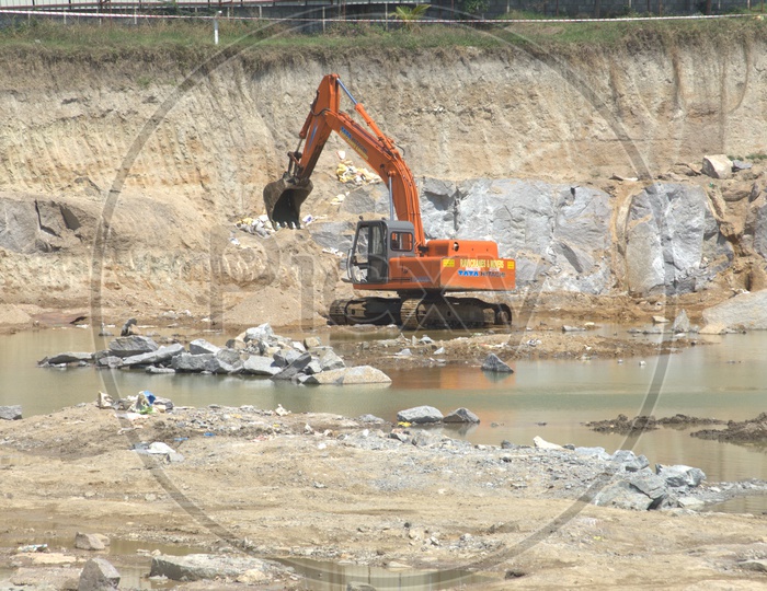 Bulldozer excavating the massive rock bodies