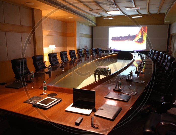 Round table conference room alongside the projector display