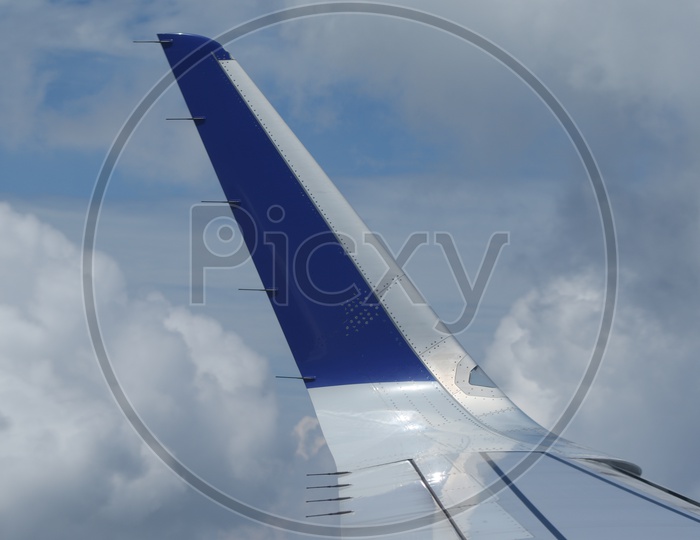 Indogo flight wing with clouds in the background