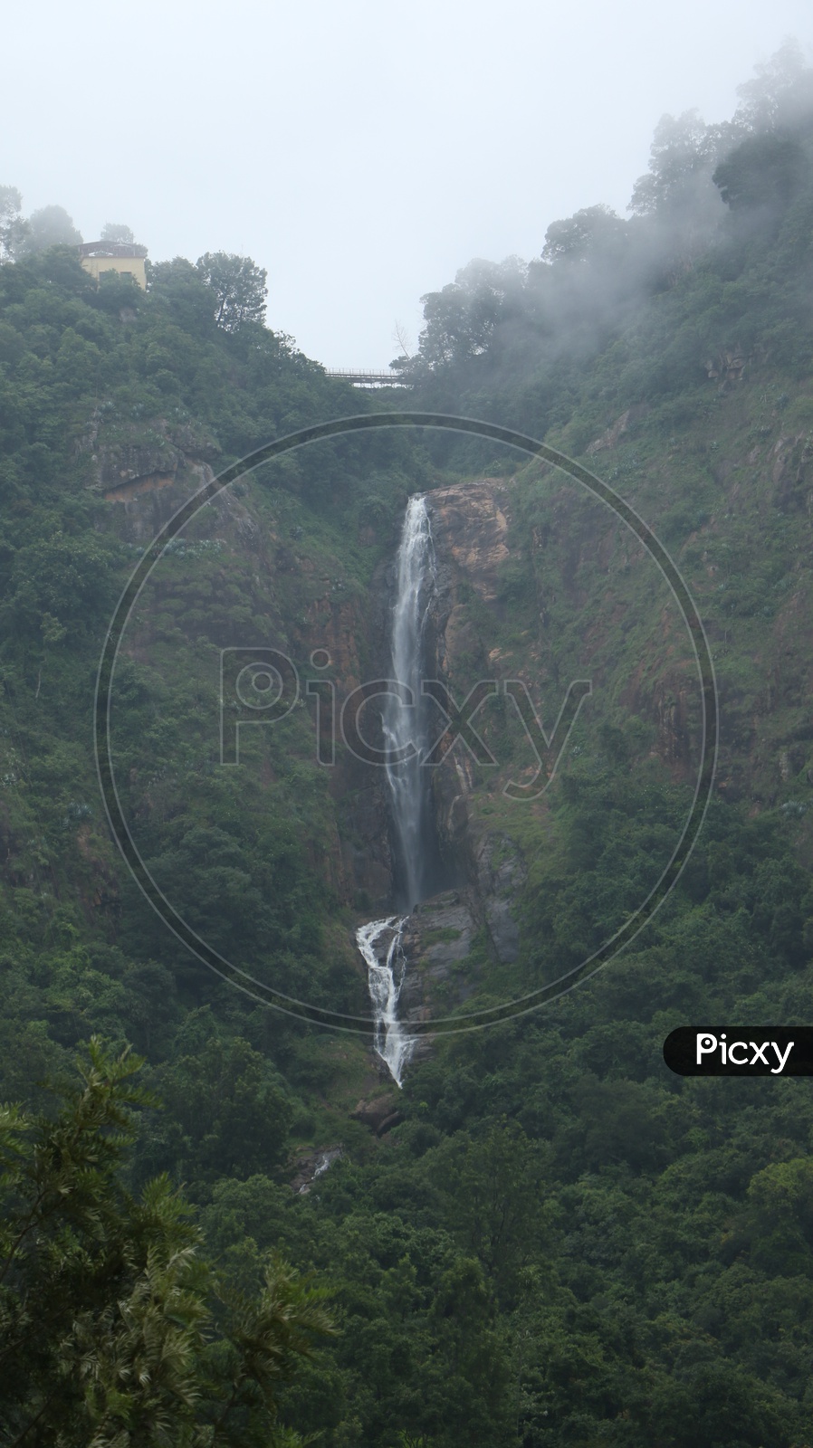 A Water Falls Falling From The top of rocks in a hill In Ooty