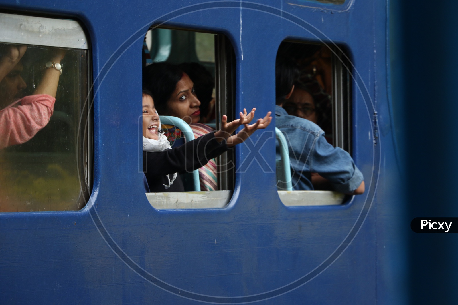 A child Putting His hands Out From Train Window and Smiling In a  Ooty Train