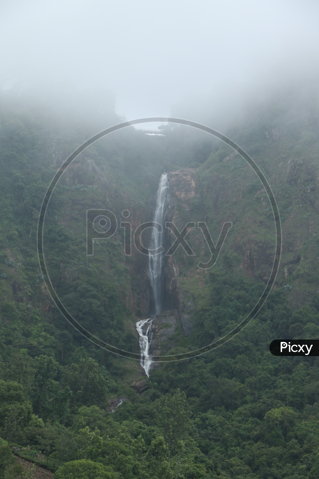 A Water Falls Falling From The top of rocks in a hill In Ooty