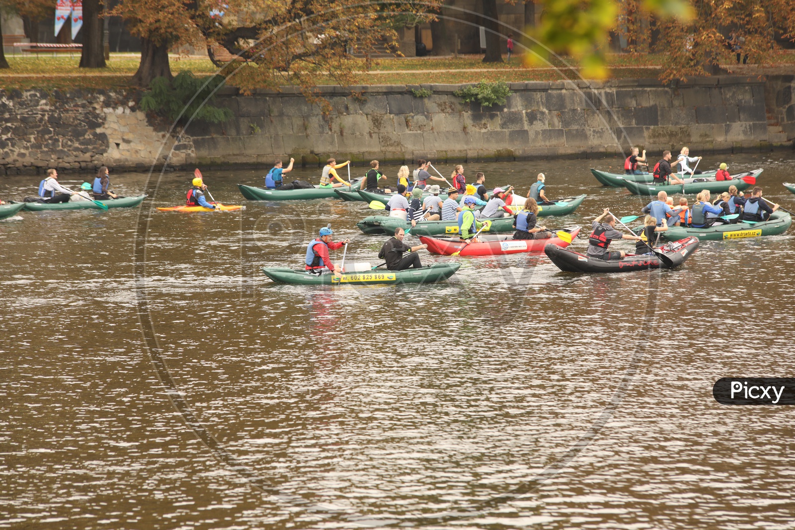 Foreigners kayaking alongside the city