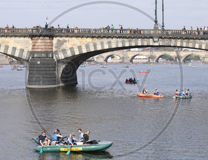 Tourists kayaking under the bridge