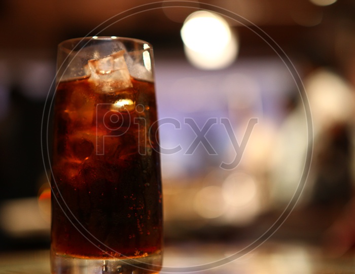 Soft drink with ice cubes in a glass