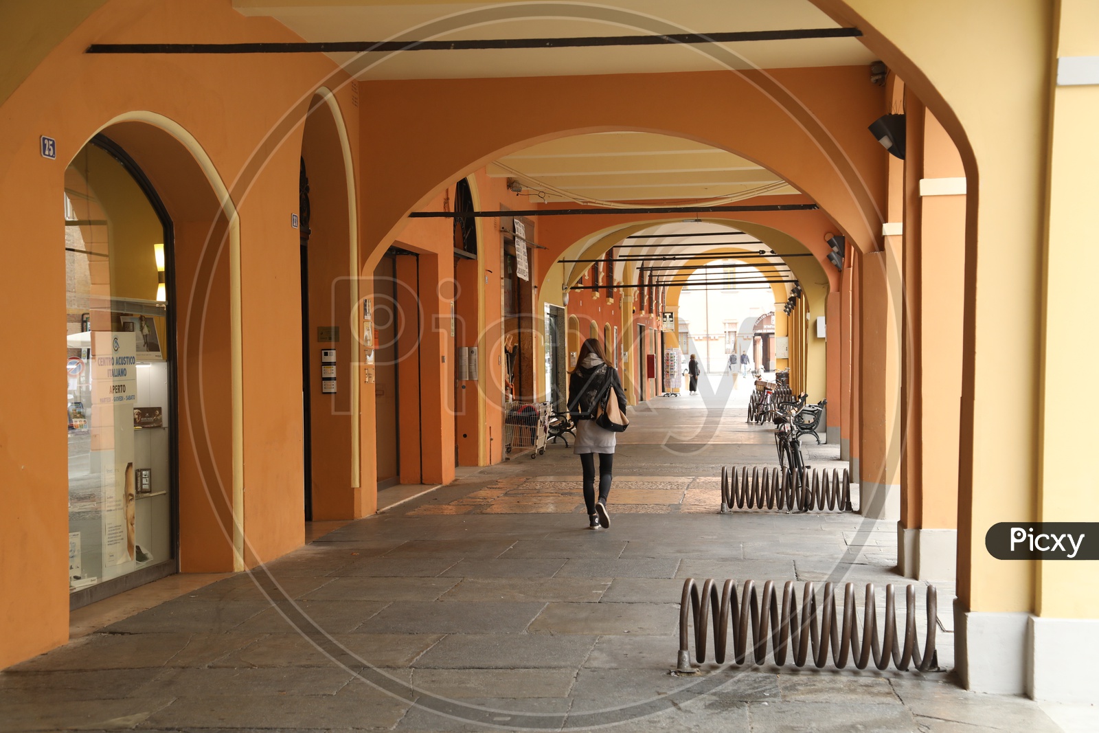 Woman walking along the pathway of a hall