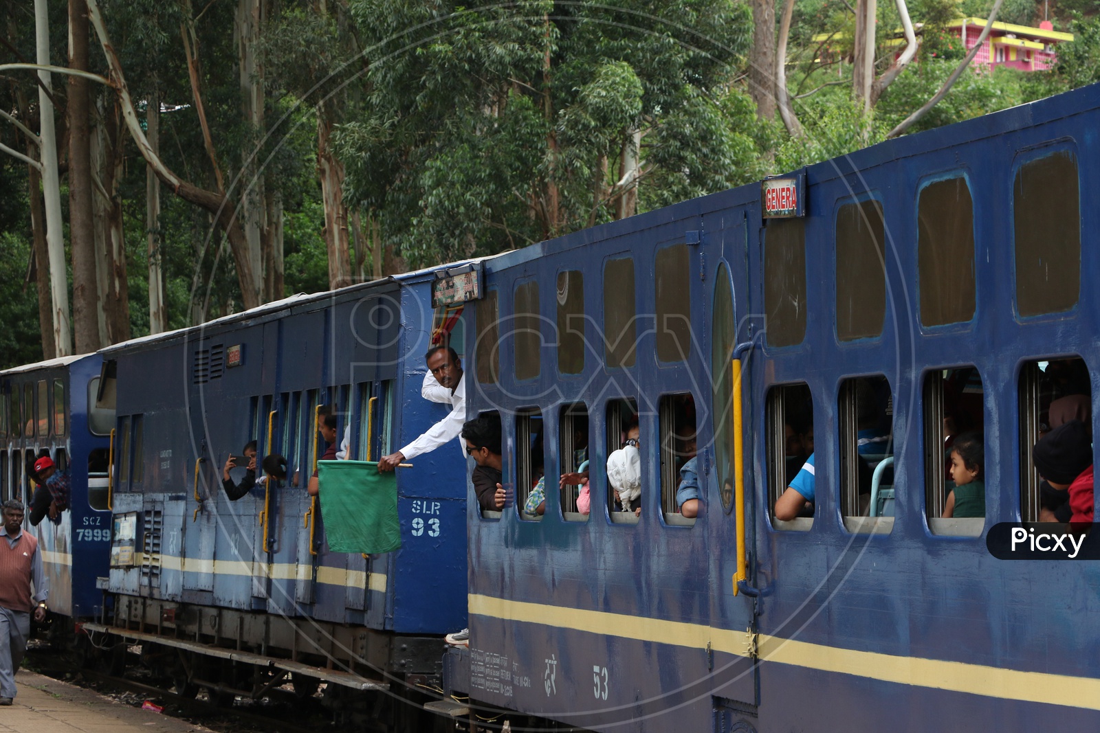 Train Guard Waving a Green Flag in a Train , nilgiri Mountain Railways