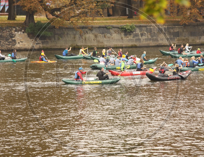 Foreigners kayaking alongside the city