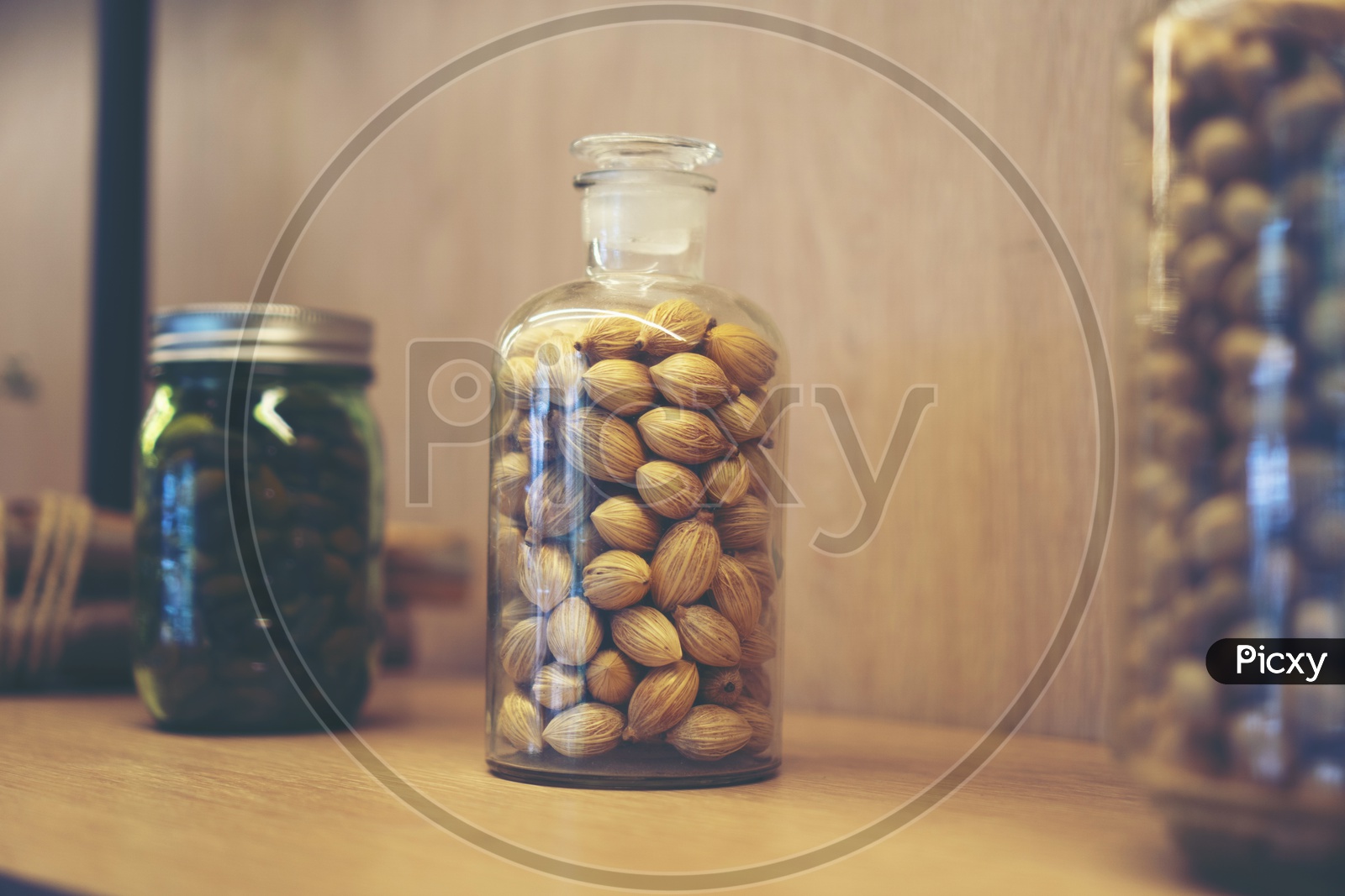 Cardamom in a Glass Jar At Kitchen Table