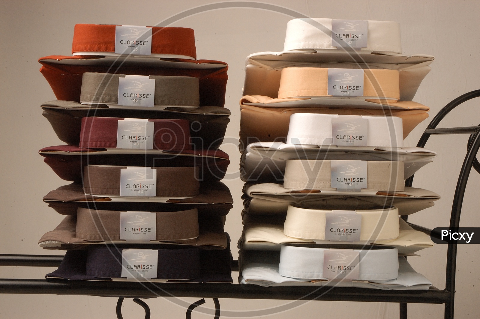Stack of folded cotton men's shirts in multi color
