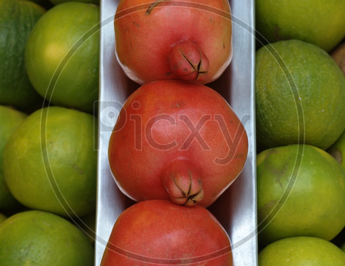 Close up shot of pomegranate fruit with oranges