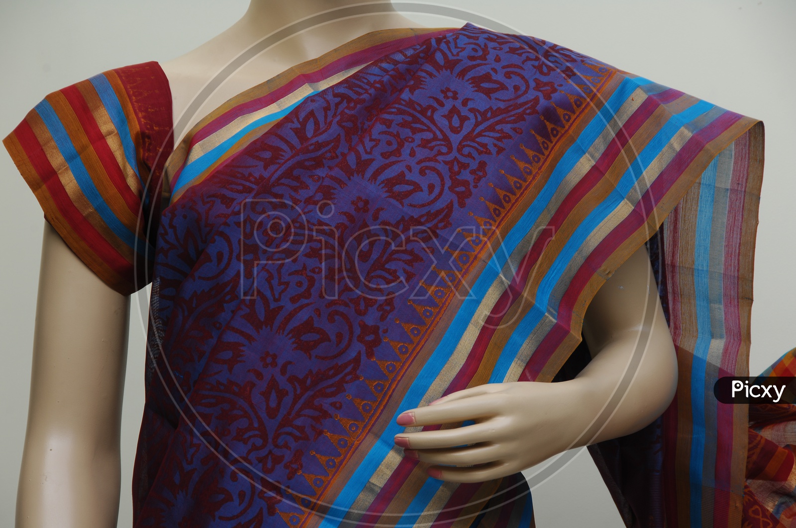 Close up shot of a Mannequin draped in a traditional Indian purple saree