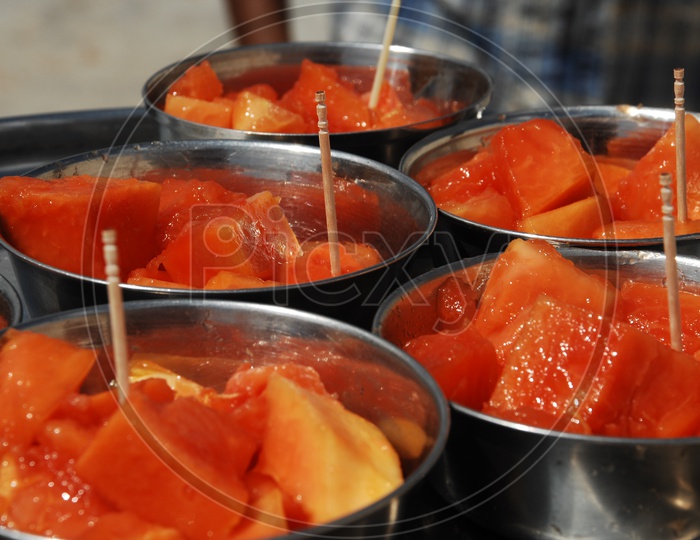 Photograph of Papaya fruit pieces served in steel bowls