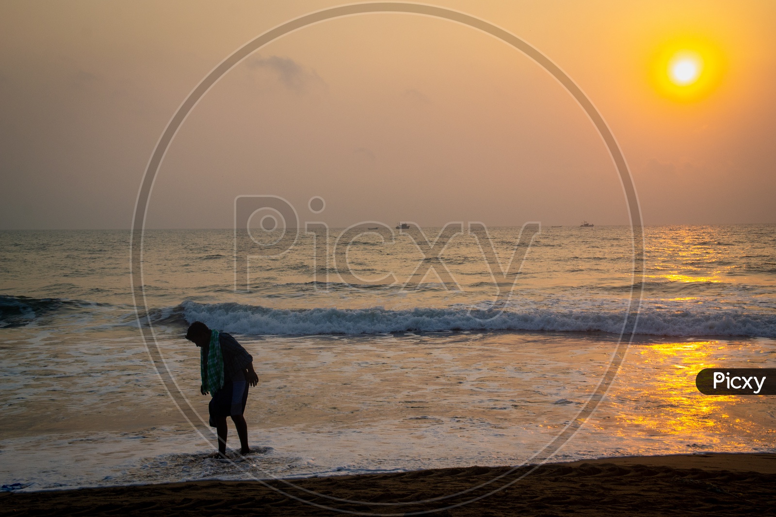 Man bathing at a beach during sunrise