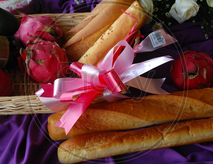 Bread Sticks With Dragon Fruit , avocado and Wine Bottle Presentation in a Basket