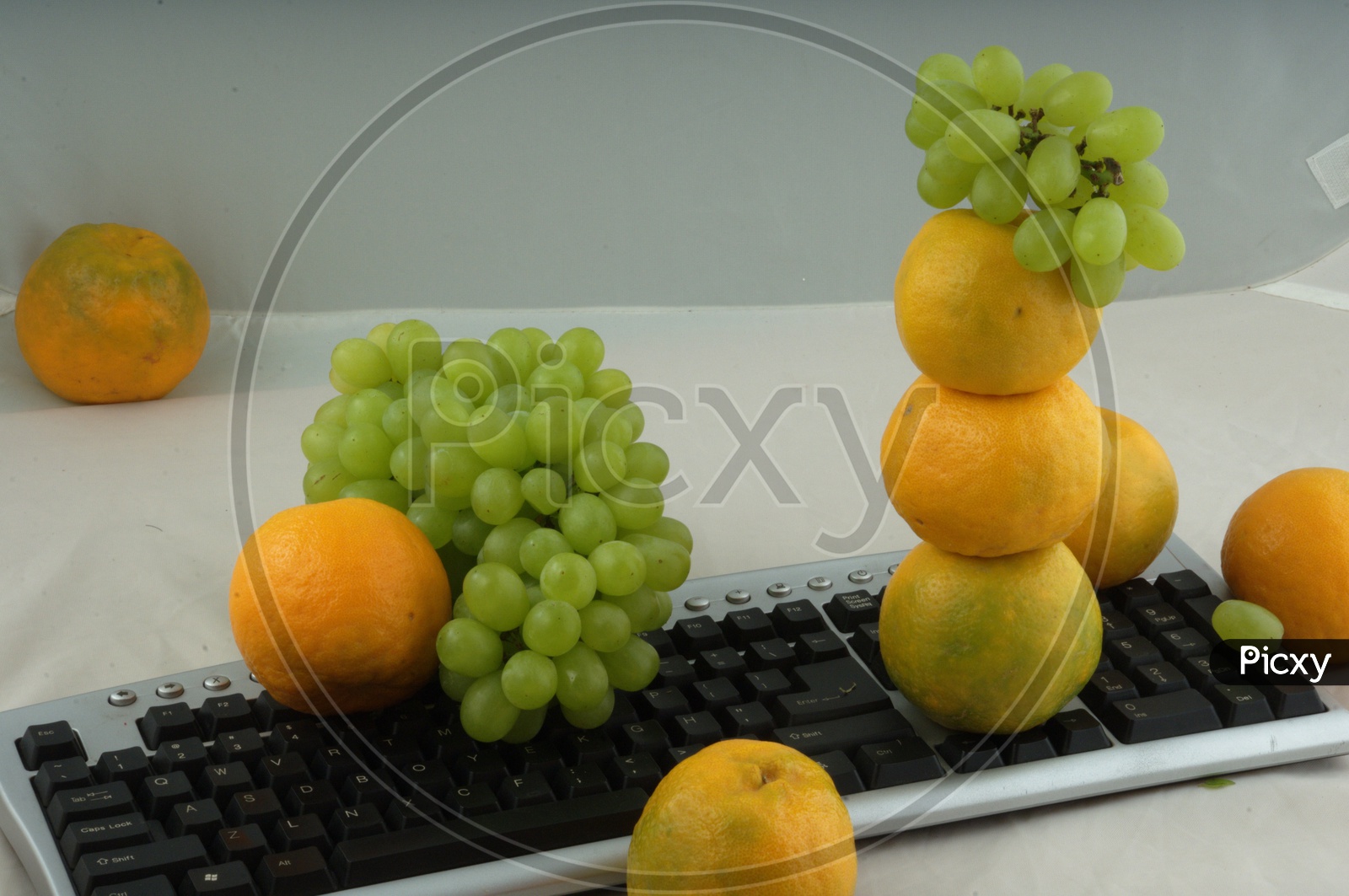 Oranges and grape fruits on Keyboard