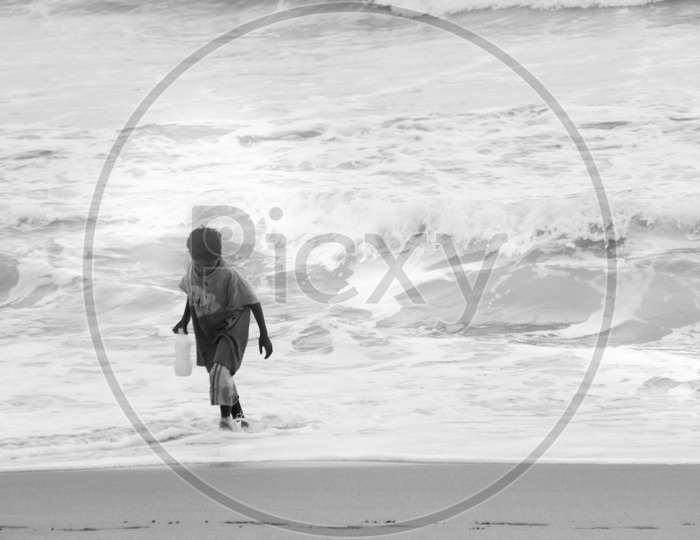 Boy taking water from beach