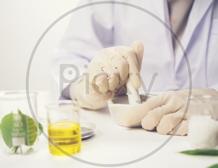 Woman Doctor Making medicine From Herbal Leafs  In a lab