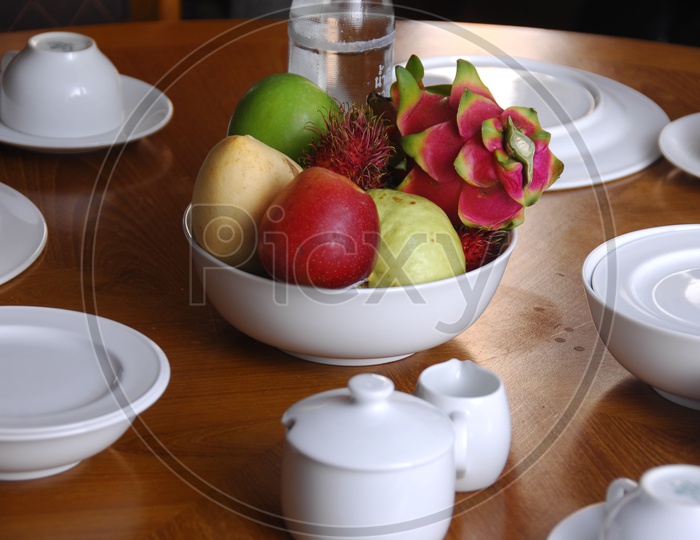 Photograph of fruits in a bowl on Dining Table