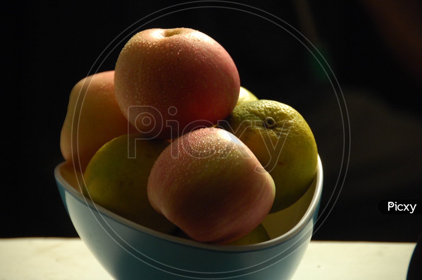 Apples and Mosambi Fruit or Citrus Fruit in a Bowl