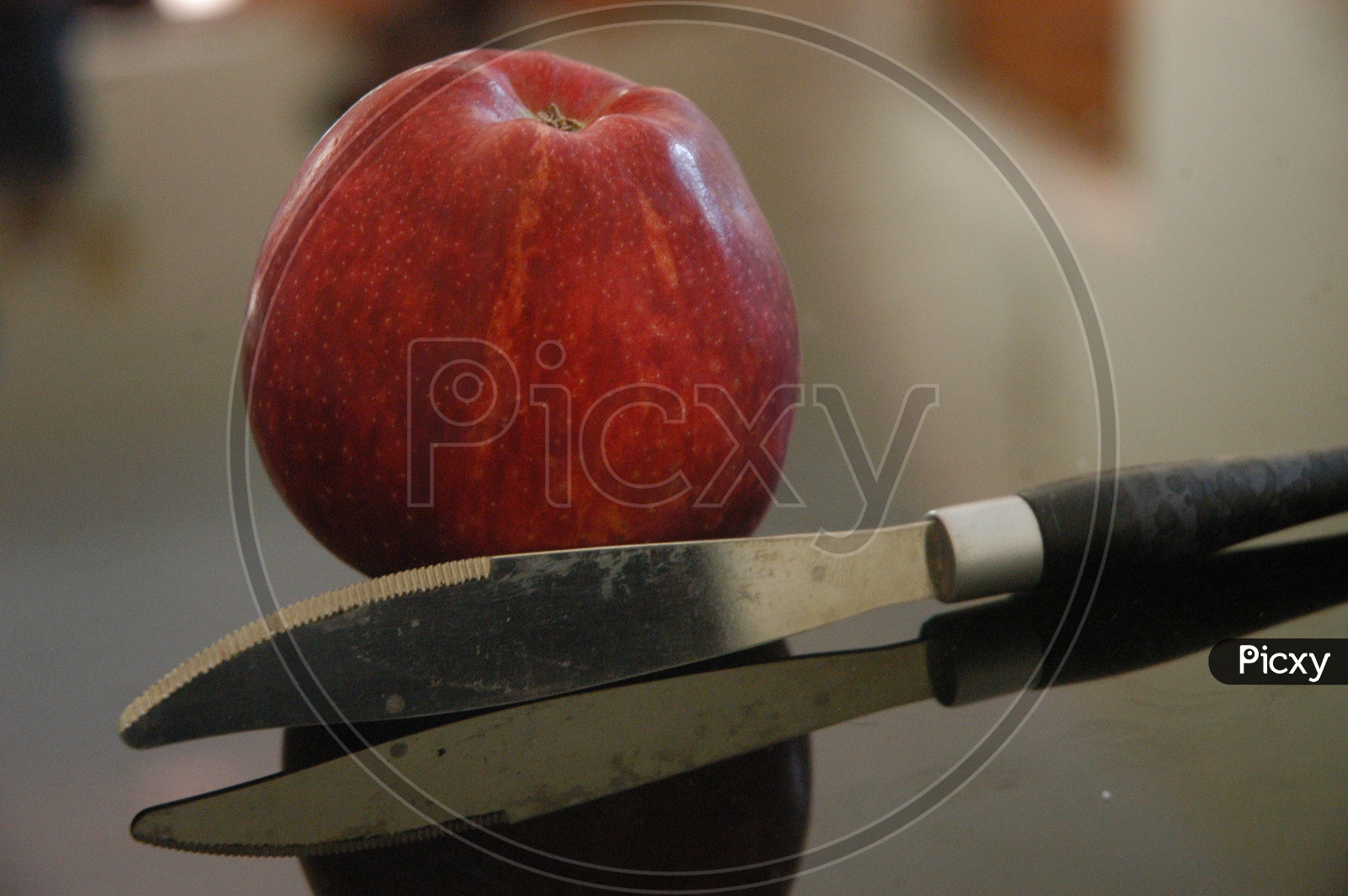 Close up shot of fresh red apple with knife