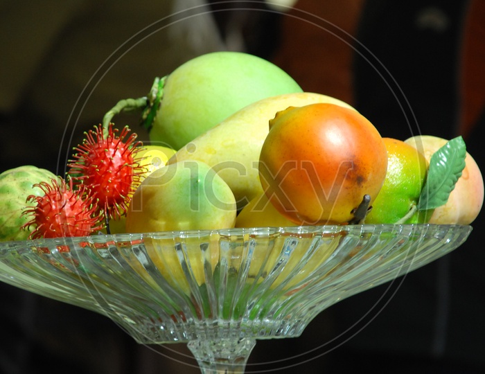 Photograph of Artificial Fruits in a glass bowl