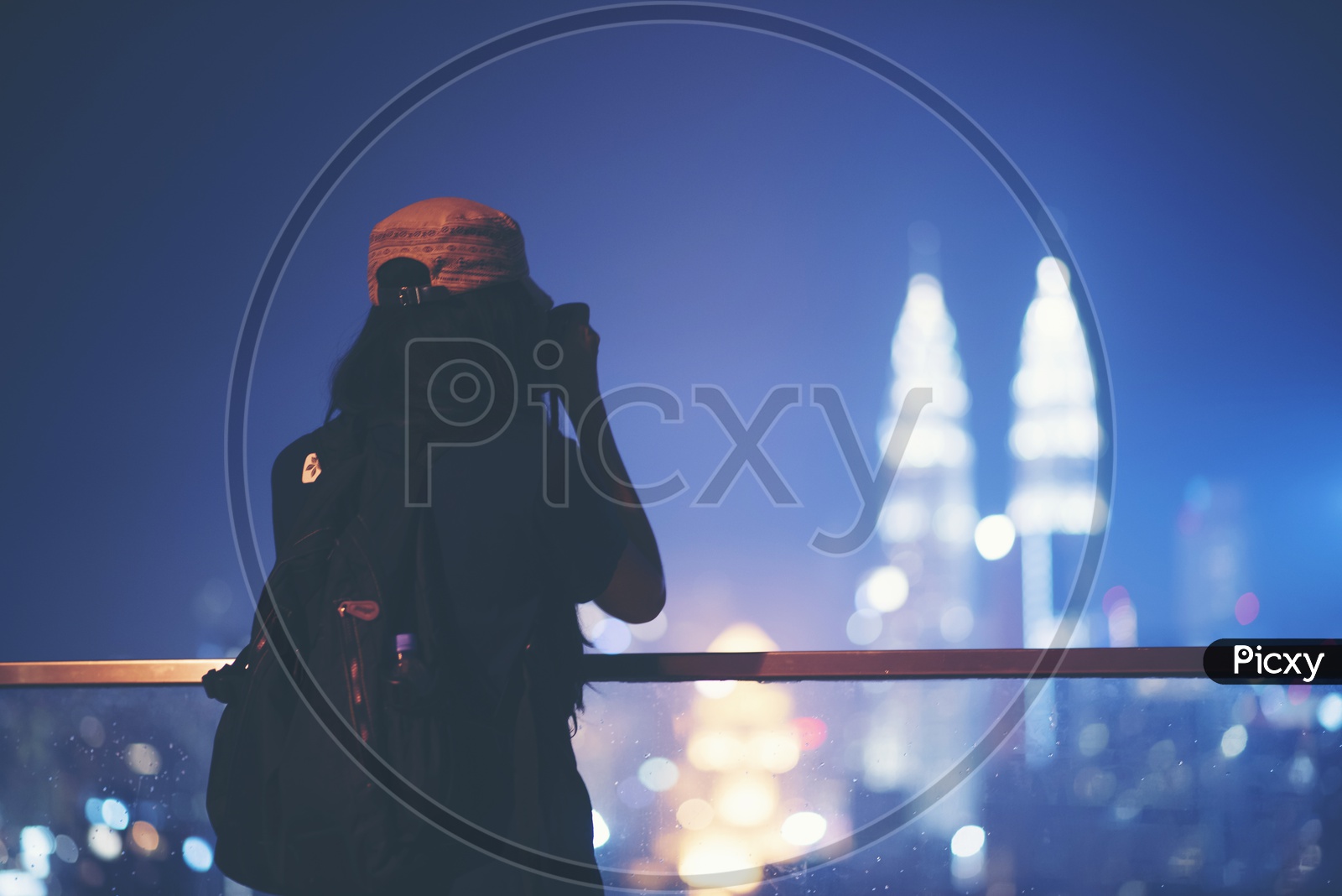 A Photographer Taking the Picture Of Petronas towers From A High Rise Building Roof Top