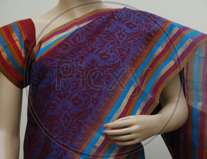 Close up shot of a Mannequin draped in a traditional Indian purple saree