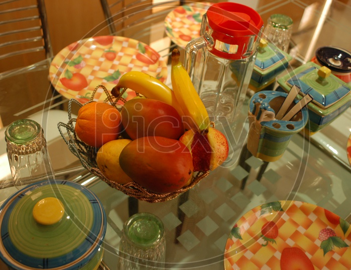Photograph of artificial fruits in a bowl on dining table