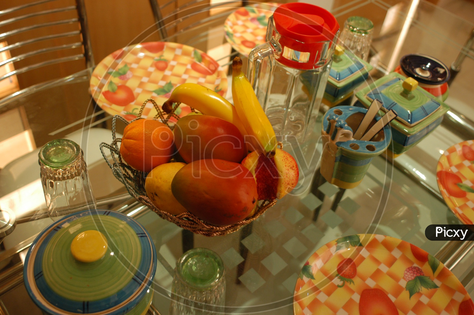 Photograph of artificial fruits in a bowl on dining table