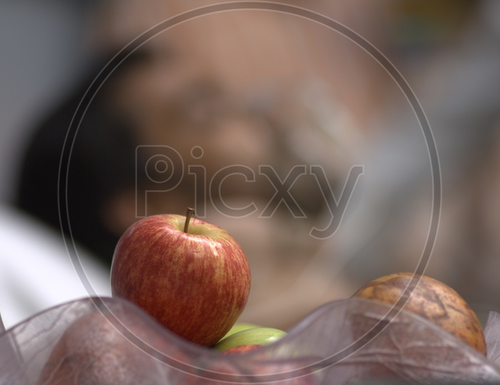 Close up shot of Apple fruit with man in blur background
