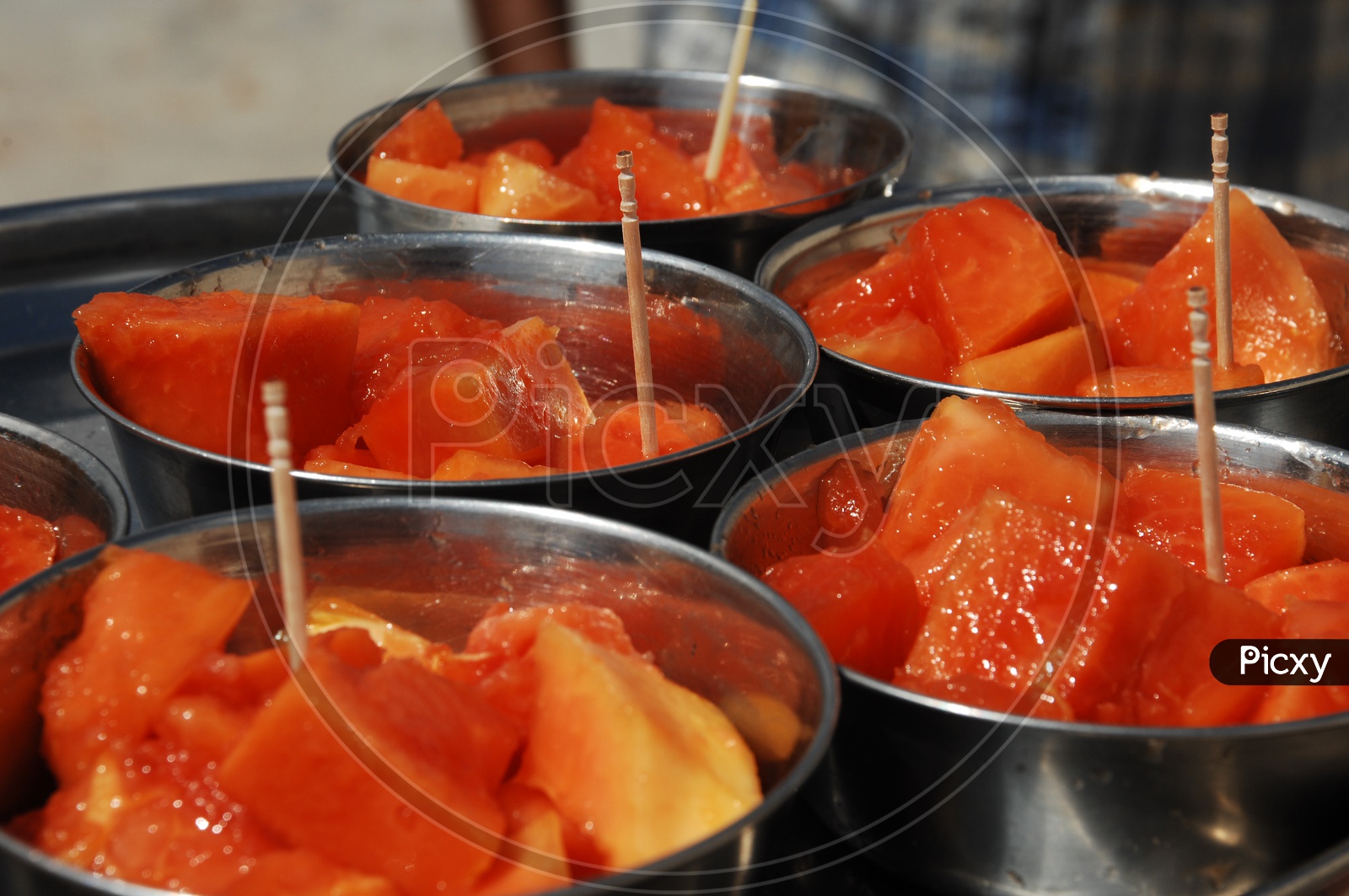 Photograph of Papaya fruit pieces served in steel bowls