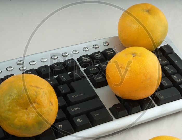 Photographs of oranges on a computer keyboard