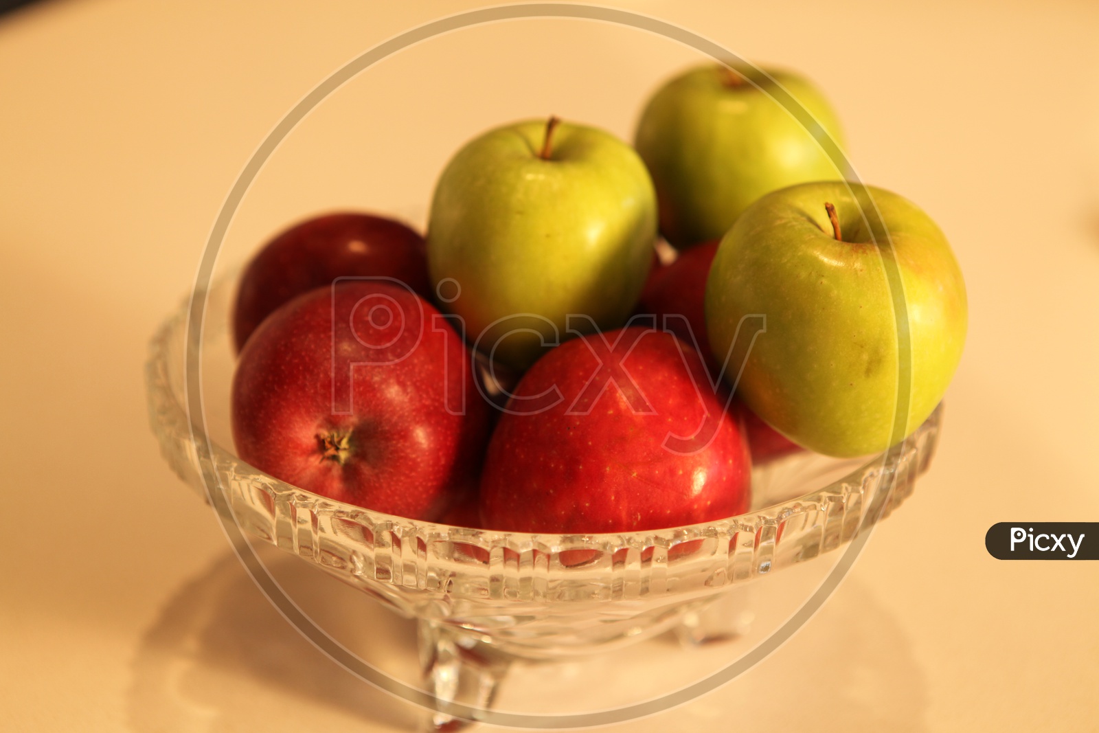 Photograph of green and red apples in a bowl